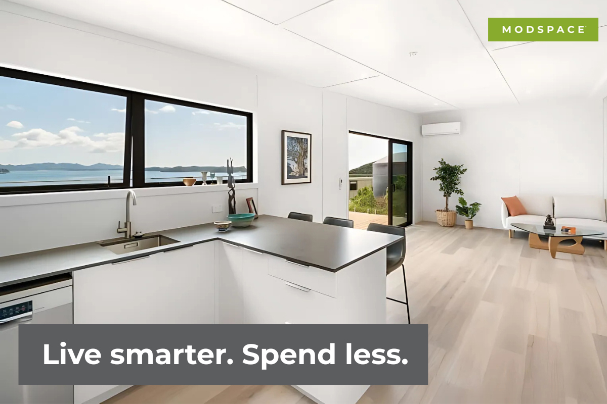 A modern kitchen featuring a window with an ocean view, showcasing the concept of transportable homes.